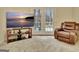 Cozy Bonus Room featuring a large-screen TV, comfortable recliner, and sliding doors to the outside at 215 Farr Lake Dr, Tyrone, GA 30290