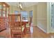 Formal dining room with a light wood table, matching chairs, built-in hutch, and bay window at 215 Farr Lake Dr, Tyrone, GA 30290