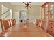 Bright dining room with a long table, seating for six, and a classic china cabinet at 215 Farr Lake Dr, Tyrone, GA 30290