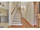 Welcoming entryway featuring hardwood floors, a carpeted staircase, and a view into the living room at 215 Farr Lake Dr, Tyrone, GA 30290