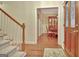 Elegant entryway featuring hardwood floors, a staircase, and a glimpse into the dining room at 215 Farr Lake Dr, Tyrone, GA 30290