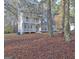 Beautiful two-story home with a spacious porch and stone accents surrounded by mature trees at 215 Farr Lake Dr, Tyrone, GA 30290