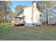 Side view of home featuring back deck with umbrella, plus second story balcony at 215 Farr Lake Dr, Tyrone, GA 30290