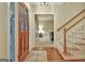 Inviting foyer with a wooden door, staircase with carpeted steps, and hardwood floors at 215 Farr Lake Dr, Tyrone, GA 30290
