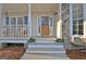 Charming front door with glass panes and stone accents, adorned with potted plants at 215 Farr Lake Dr, Tyrone, GA 30290
