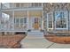 Charming front entrance featuring a beautiful wood door, stone accents and a welcoming porch at 215 Farr Lake Dr, Tyrone, GA 30290