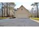 Spacious two-car garage with a concrete driveway that is surrounded by mature trees at 215 Farr Lake Dr, Tyrone, GA 30290