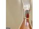 Hallway view with hardwood floors, leading to the front door and staircase of the home at 215 Farr Lake Dr, Tyrone, GA 30290