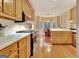 Traditional kitchen with wood cabinets, light countertops, stainless steel appliances, and a breakfast nook at 215 Farr Lake Dr, Tyrone, GA 30290