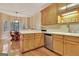 Kitchen featuring wood cabinets, stainless steel appliances, and an adjacent breakfast nook at 215 Farr Lake Dr, Tyrone, GA 30290