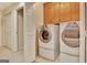 Laundry room with front load washer and dryer and upper storage cabinets at 215 Farr Lake Dr, Tyrone, GA 30290