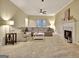 Bright living room with a large sectional sofa, fireplace, and neutral color palette at 215 Farr Lake Dr, Tyrone, GA 30290