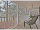 Covered porch with white railings, ceiling fan, and chairs overlooking blooming trees at 215 Farr Lake Dr, Tyrone, GA 30290