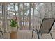 Relaxing covered porch with a view of the surrounding greenery and a side table at 215 Farr Lake Dr, Tyrone, GA 30290