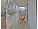 Relaxing porch with rocking chairs and a view of the surrounding greenery and flowering trees at 215 Farr Lake Dr, Tyrone, GA 30290