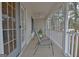 Covered porch featuring a seating area with a decorative vase and pleasant wooded view at 215 Farr Lake Dr, Tyrone, GA 30290