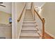 Carpeted staircase with wood railing at 215 Farr Lake Dr, Tyrone, GA 30290