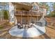 Inviting back patio with outdoor seating, a fire pit, and a hot tub for relaxation at 125 Tall Timber Ct, Fayetteville, GA 30215