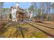 Expansive backyard featuring a multi-level deck, patio with outdoor seating, and a trampoline at 125 Tall Timber Ct, Fayetteville, GA 30215