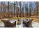 Beautiful wooded backyard featuring a fire pit and chairs with views of the forest at 125 Tall Timber Ct, Fayetteville, GA 30215
