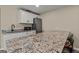 Granite counters and stainless steel appliances create this additional kitchen space at 125 Tall Timber Ct, Fayetteville, GA 30215