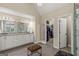Elegant bathroom with double vanity, a walk-in shower, a standalone tub and lots of natural light at 125 Tall Timber Ct, Fayetteville, GA 30215