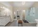 Elegant bathroom with double vanity, a walk-in shower, a standalone tub and lots of natural light at 125 Tall Timber Ct, Fayetteville, GA 30215