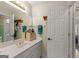 Bathroom featuring a large mirror and a single sink vanity with gold hardware at 125 Tall Timber Ct, Fayetteville, GA 30215