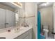 Bathroom with a single sink vanity, a large mirror, and a walk-in shower with blue curtain at 125 Tall Timber Ct, Fayetteville, GA 30215