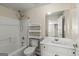 Clean, white bathroom with a shower-tub combo, modern fixtures, and ample storage at 125 Tall Timber Ct, Fayetteville, GA 30215