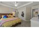 Spacious bedroom featuring a trey ceiling with a ceiling fan and plush carpeted floors at 125 Tall Timber Ct, Fayetteville, GA 30215