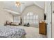 Bright bedroom with vaulted ceiling, ceiling fan, lots of windows, a seating area, and a large bed at 125 Tall Timber Ct, Fayetteville, GA 30215