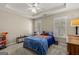 Cozy bedroom with carpet, two windows for natural light, and a ceiling fan at 125 Tall Timber Ct, Fayetteville, GA 30215