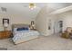 Spacious bedroom with vaulted ceiling, a large bed, sitting area, and walk-in closet at 125 Tall Timber Ct, Fayetteville, GA 30215