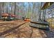 Boat storage in the wooded yard that has several canoes and kayaks available for use at 125 Tall Timber Ct, Fayetteville, GA 30215