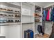 Organized walk-in closet with custom shelves and storage for shoes, luggage, and clothes at 125 Tall Timber Ct, Fayetteville, GA 30215