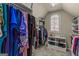 Well-organized walk-in closet with custom shelving, hanging rods, and a window at 125 Tall Timber Ct, Fayetteville, GA 30215