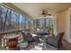 Cozy covered deck with comfortable seating, a ceiling fan, and a view of the wooded backyard at 125 Tall Timber Ct, Fayetteville, GA 30215