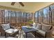 Relaxing covered deck with a ceiling fan, comfortable seating and serene views of the surrounding woods at 125 Tall Timber Ct, Fayetteville, GA 30215