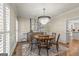 Elegant dining room with a chandelier, hardwood floors, and wainscoting at 125 Tall Timber Ct, Fayetteville, GA 30215