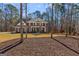 Two-story brick home with mature trees, lush lawn, and classic architectural details at 125 Tall Timber Ct, Fayetteville, GA 30215
