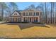 Beautiful two-story brick home with a welcoming front porch and well-manicured lawn at 125 Tall Timber Ct, Fayetteville, GA 30215
