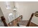 Bright foyer with hardwood floors, a chandelier, and stairs with wood and white railing at 125 Tall Timber Ct, Fayetteville, GA 30215