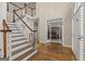 Bright foyer featuring hardwood floors, staircase and an entryway to the home office at 125 Tall Timber Ct, Fayetteville, GA 30215