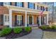 Inviting front porch with rocking chairs, brick facade and a beautifully decorated front door at 125 Tall Timber Ct, Fayetteville, GA 30215