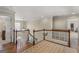Upstairs landing with hardwood floors, a carpeted landing, and natural light from a window at 125 Tall Timber Ct, Fayetteville, GA 30215