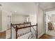 Traditional hallway with a wood floor, white trim, a decorative carpet and multiple doors at 125 Tall Timber Ct, Fayetteville, GA 30215