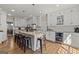 Well-equipped kitchen with a large island, seating, stainless appliances, and a beverage cooler perfect for entertaining at 125 Tall Timber Ct, Fayetteville, GA 30215