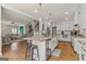Open concept kitchen with island, barstool seating, granite countertops, and views of the living area at 125 Tall Timber Ct, Fayetteville, GA 30215