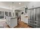 Bright kitchen with stainless steel appliances, island with seating, and hardwood floors for a modern, open feel at 125 Tall Timber Ct, Fayetteville, GA 30215